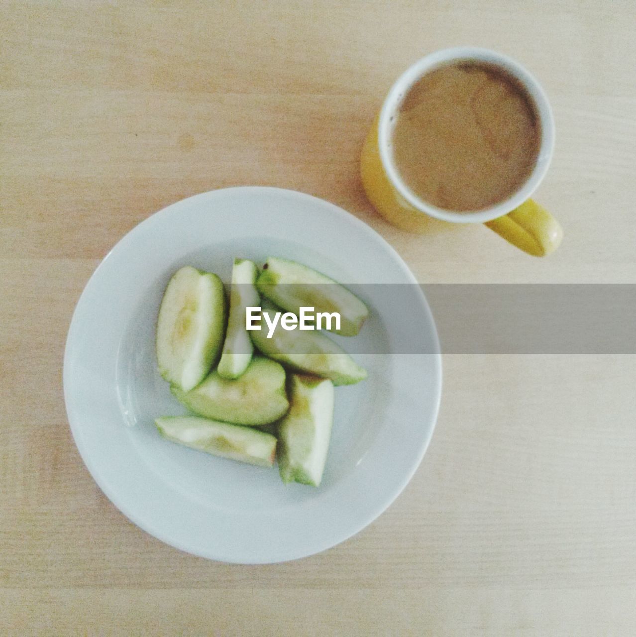 Directly above shot of green apple and tea on table