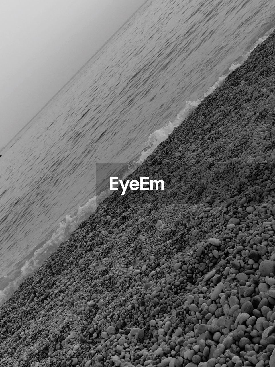 SCENIC VIEW OF SEA WITH MOUNTAIN IN BACKGROUND