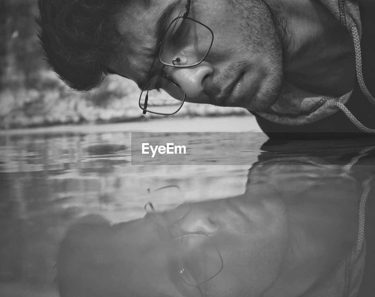 Close-up of man looking at lake