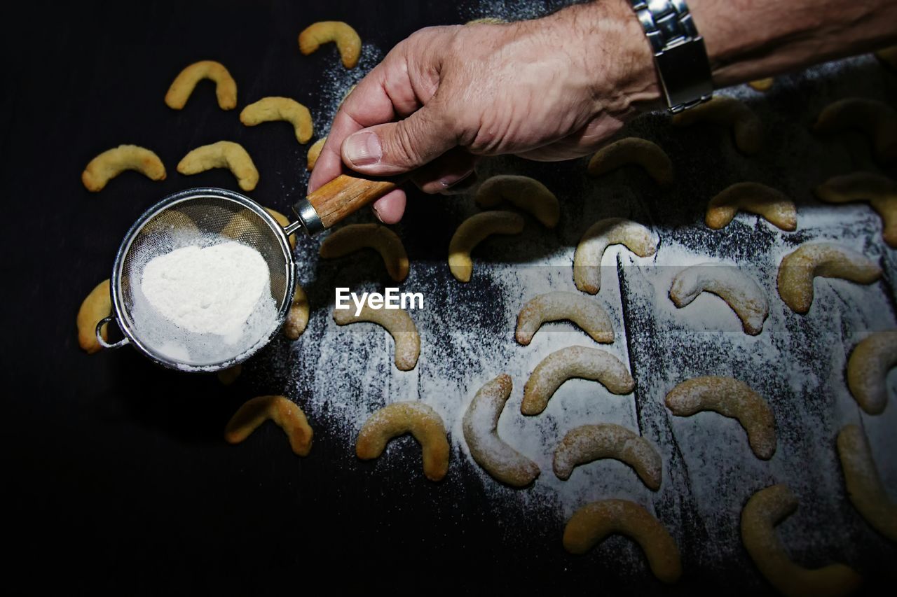 High angle view of man preparing  christmas cookies