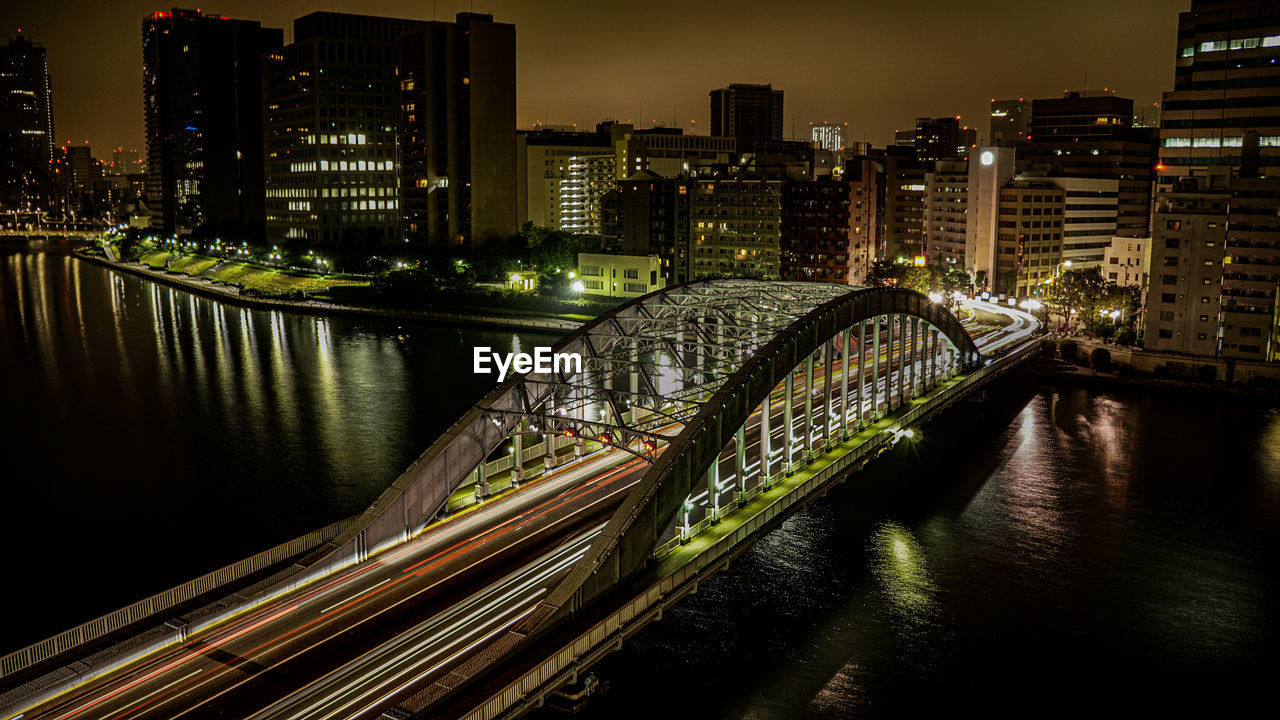 A long exposure shot of a bridge over a river in tokyo city japan