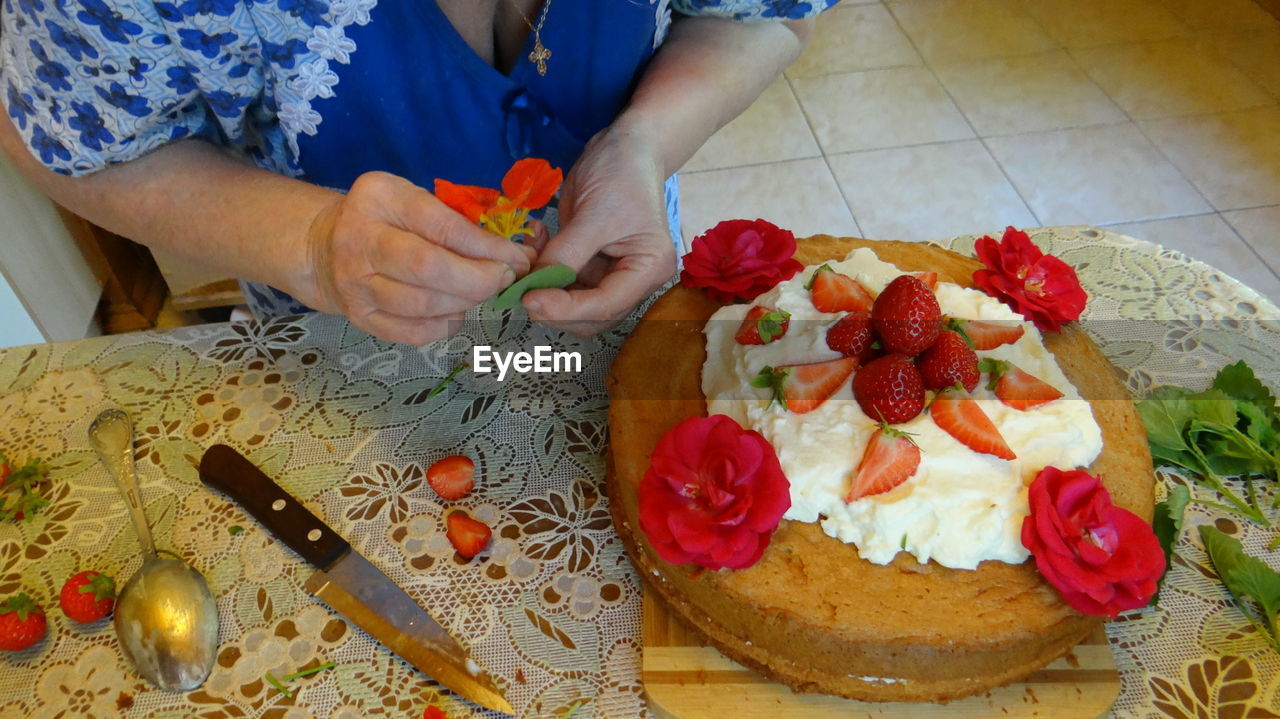 HIGH ANGLE VIEW OF WOMAN PREPARING FOOD