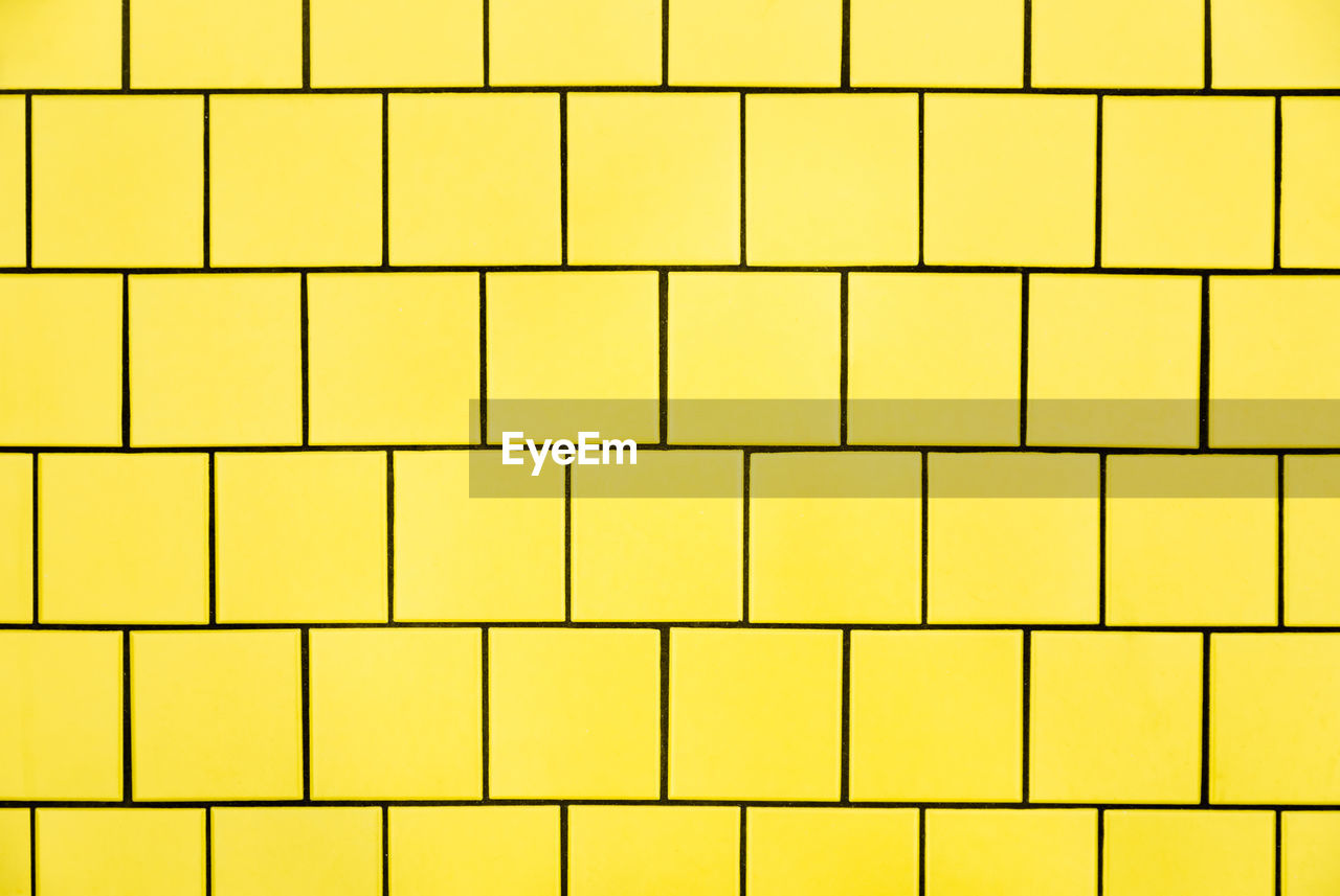 Full frame shot of yellow tiled wall