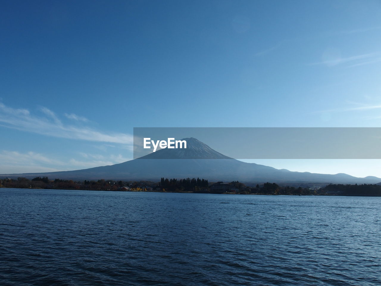 Scenic view of lake against blue sky