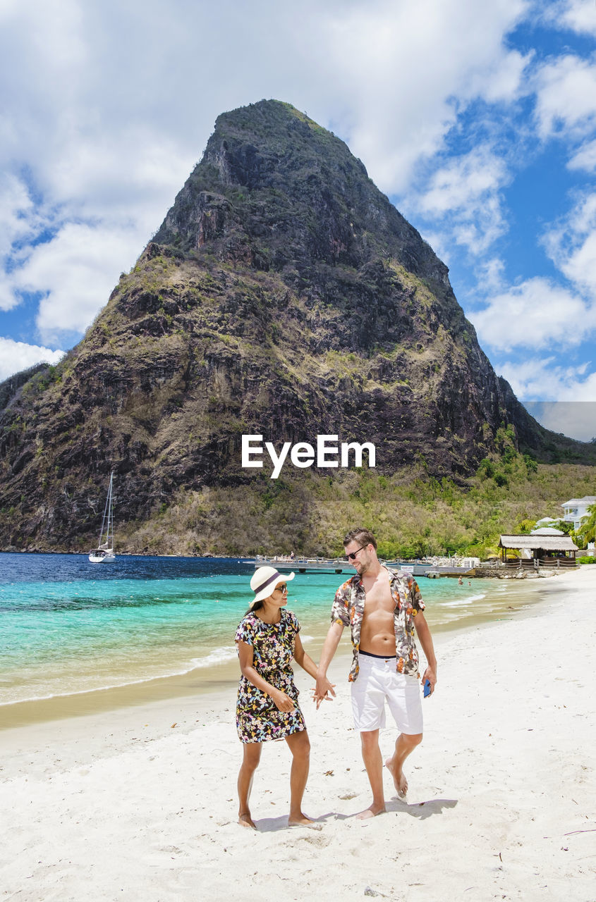 rear view of woman standing on beach