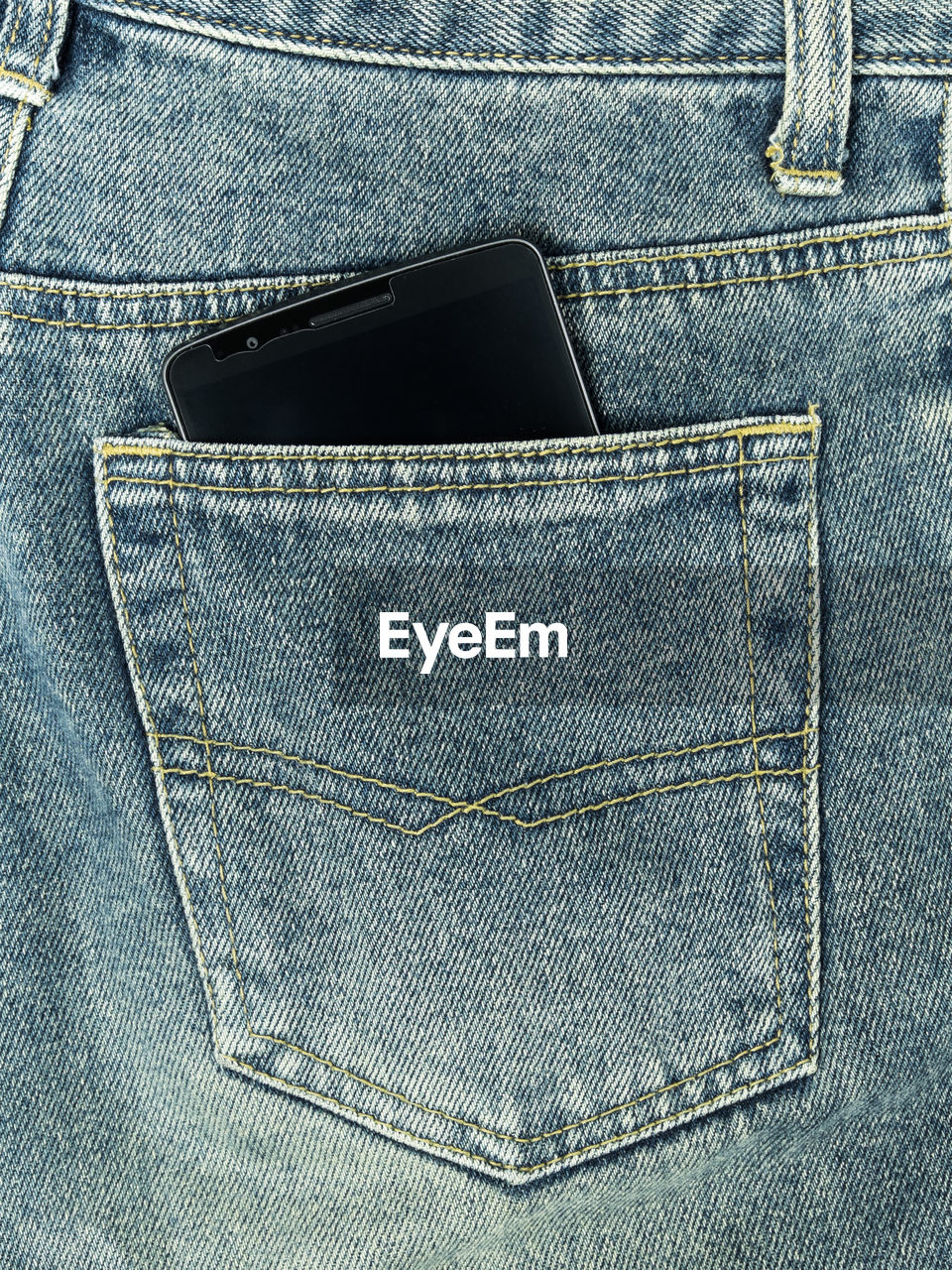 Mobile phone in jeans pocket