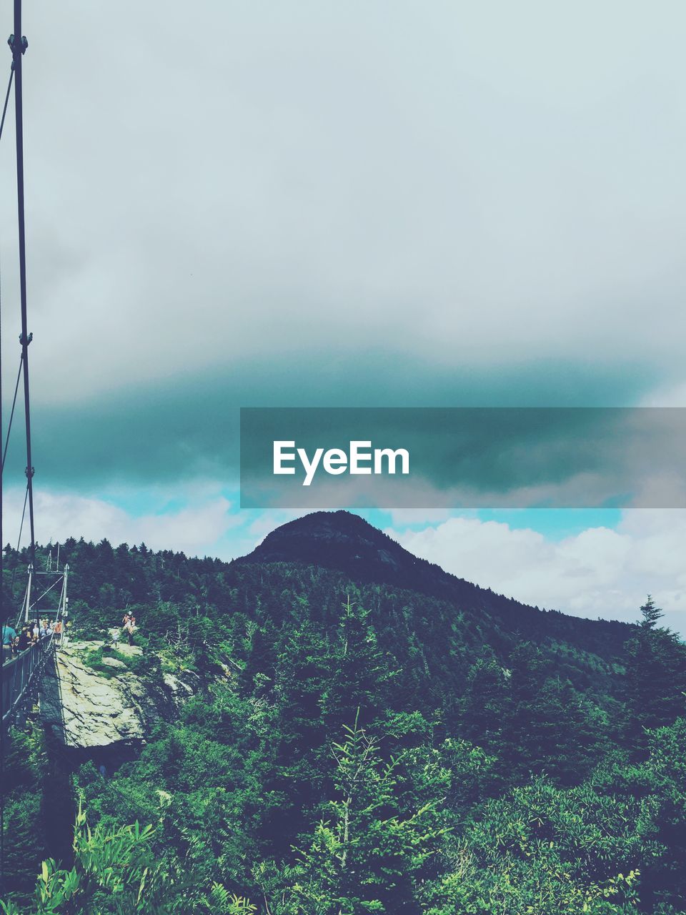 Low angle view of grandfather mountain by bridge against sky