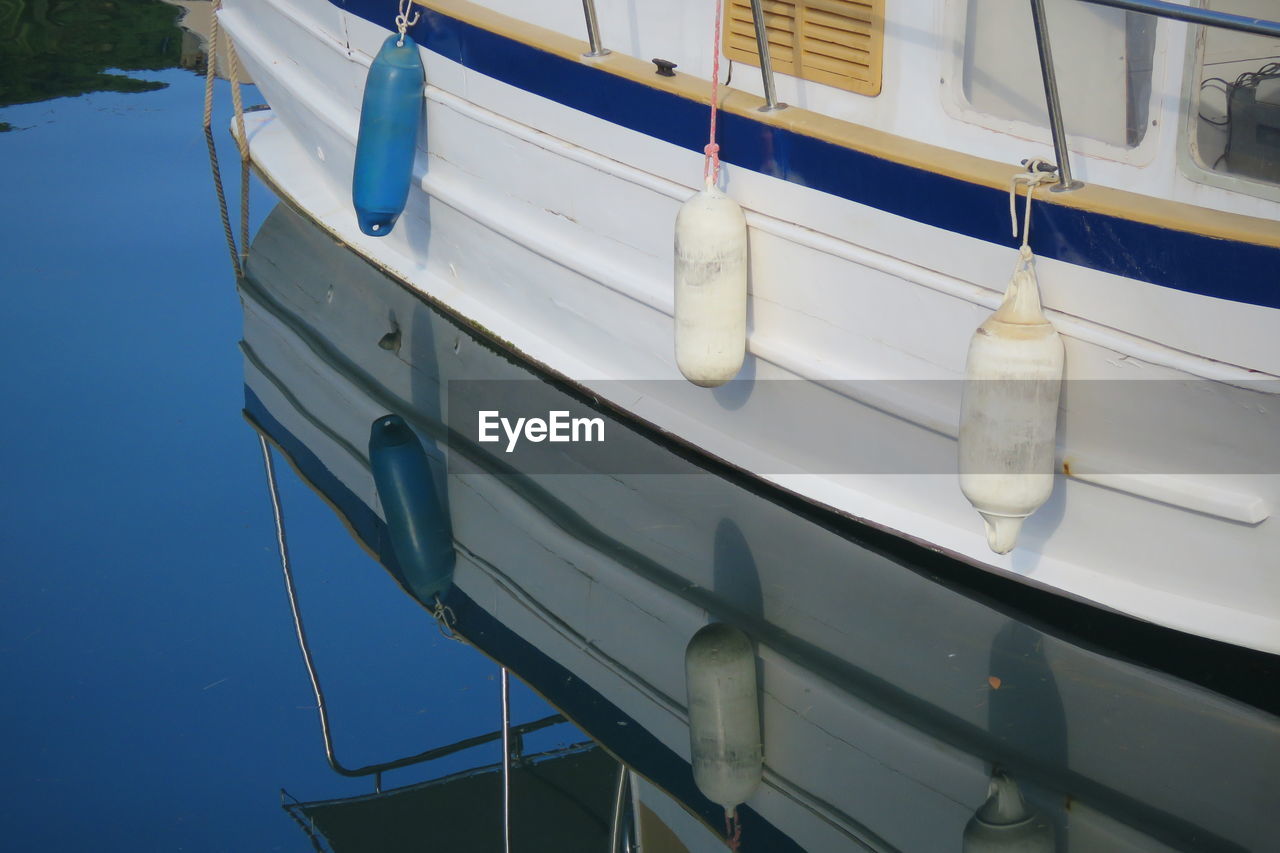 Sailboat moored in sea