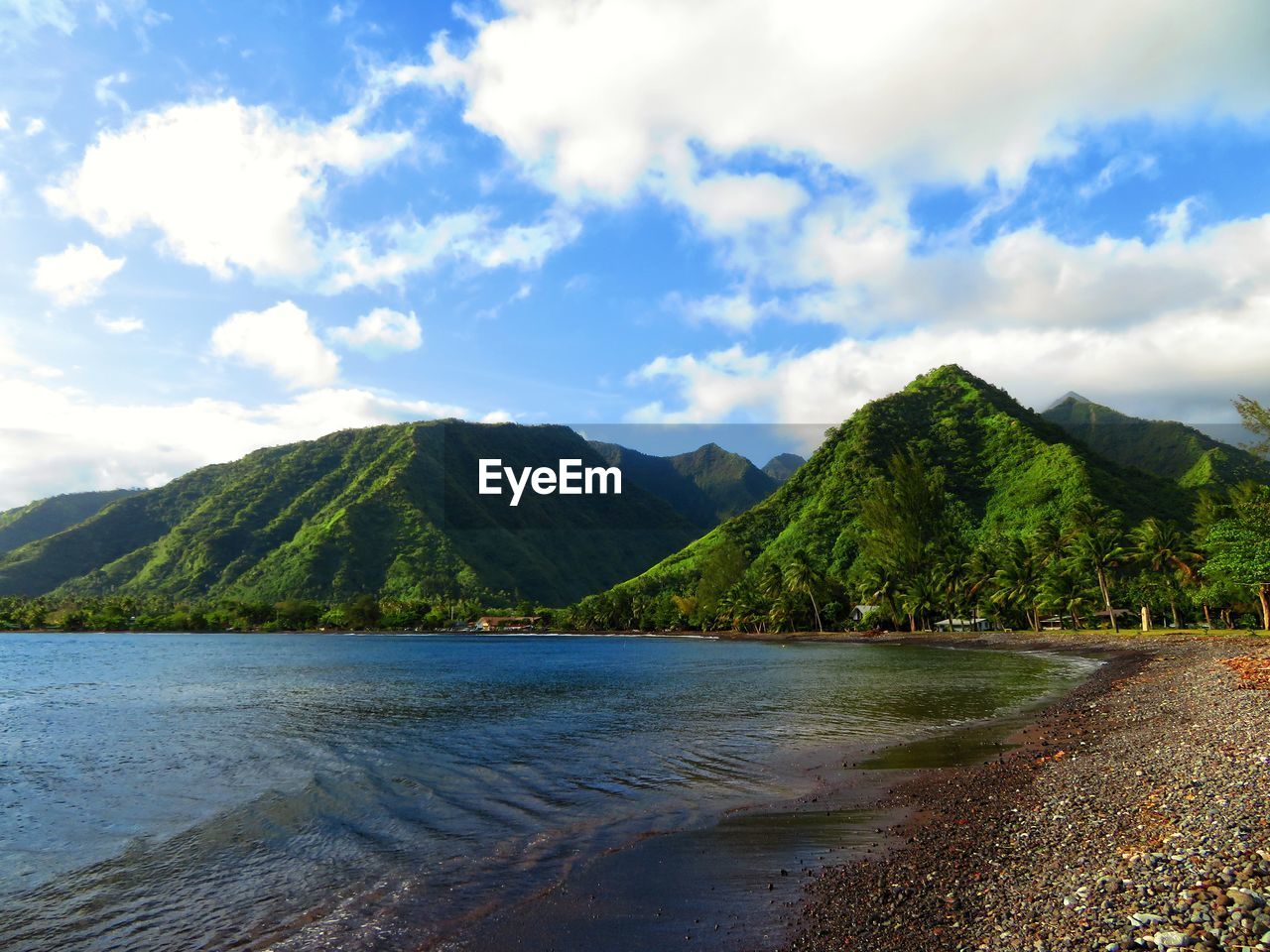 Scenic view of sea and mountains against sky