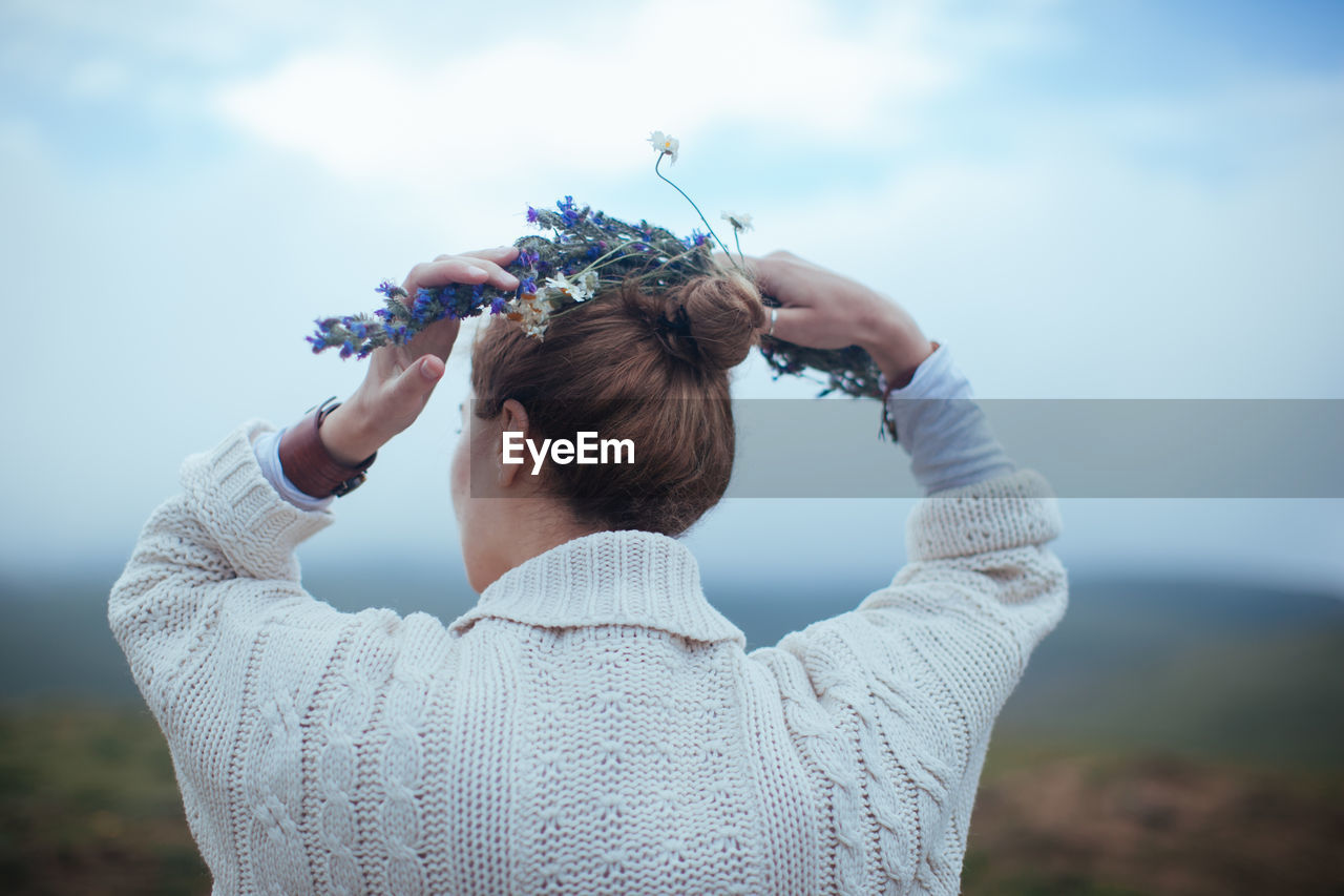 Rear view of woman against sky