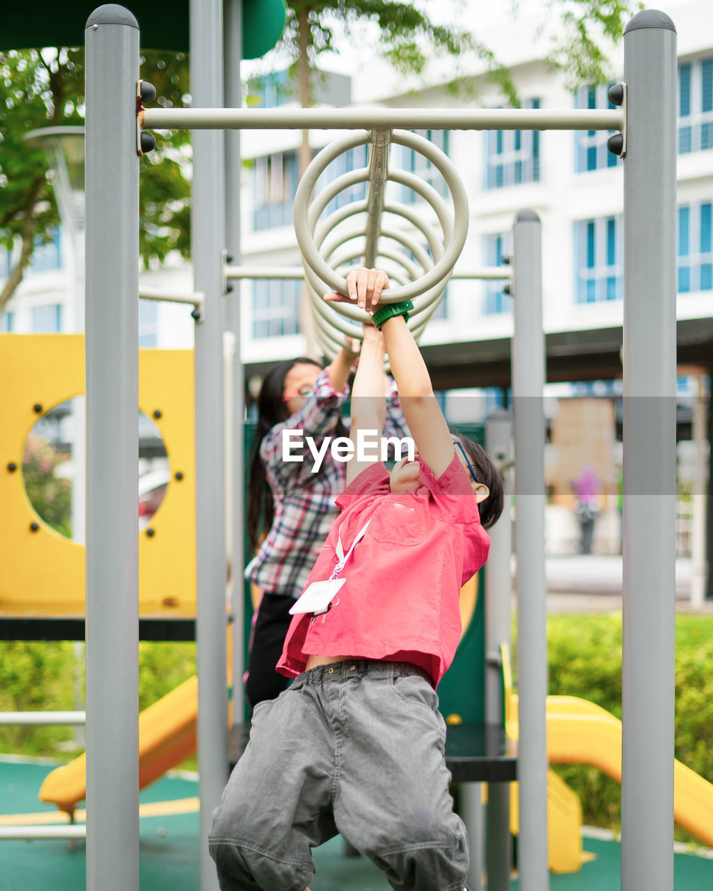 Kids playing on monkey bars at playground