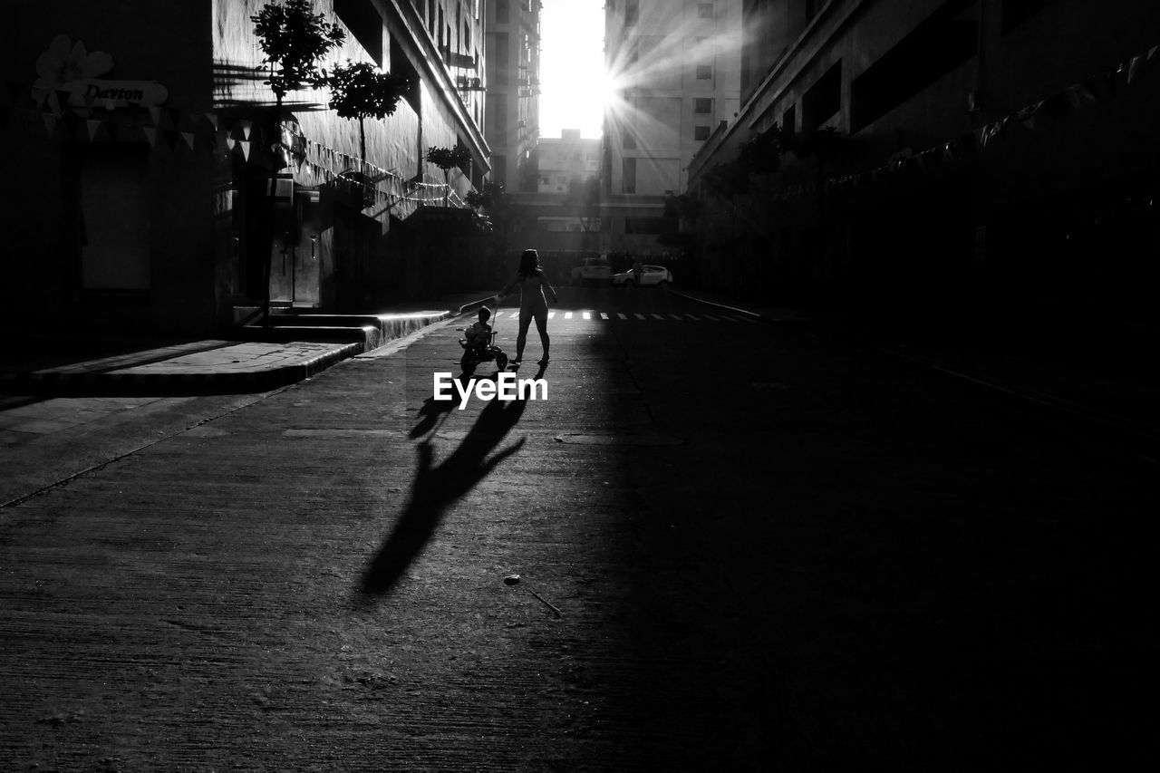 Siblings playing on street