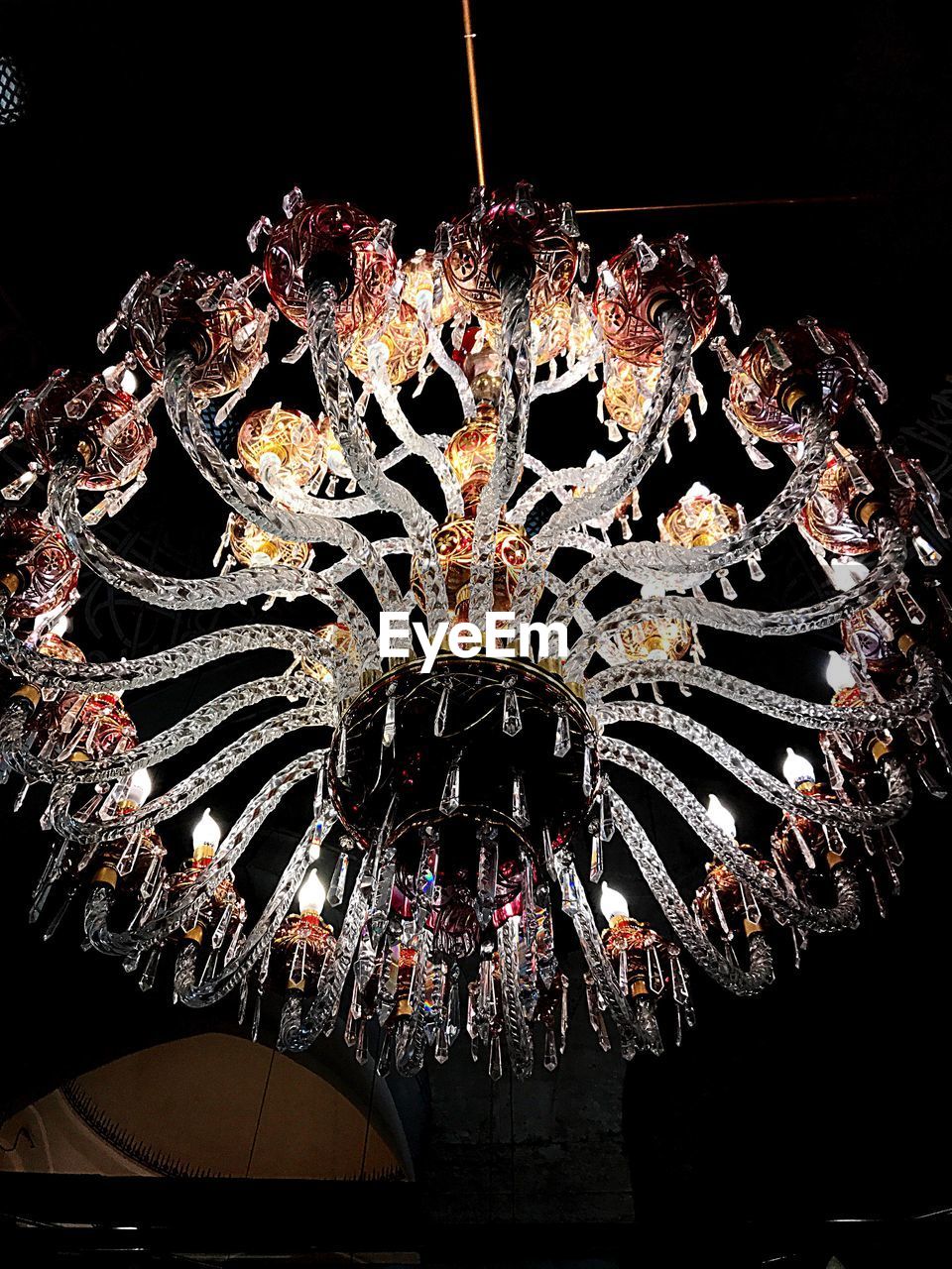 LOW ANGLE VIEW OF ILLUMINATED CHANDELIER