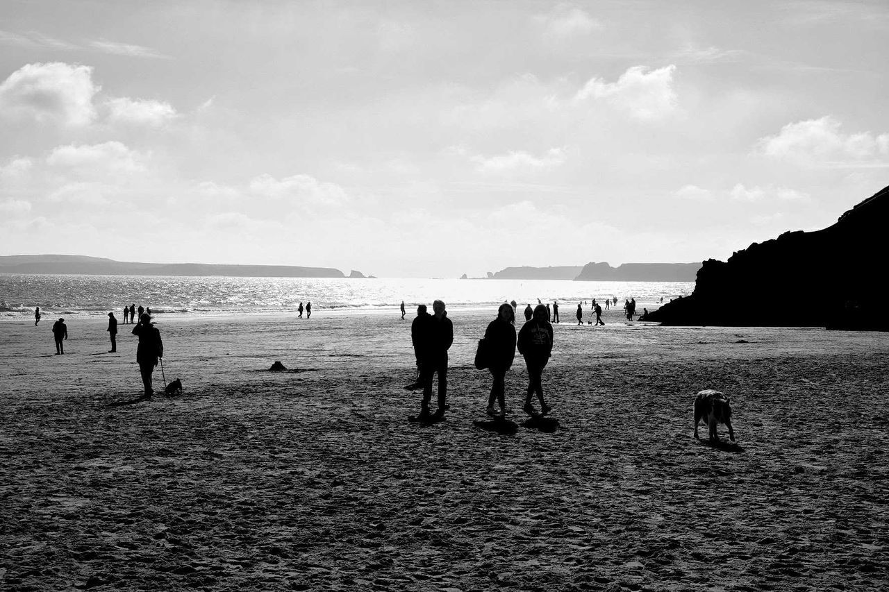 People at beach against sky