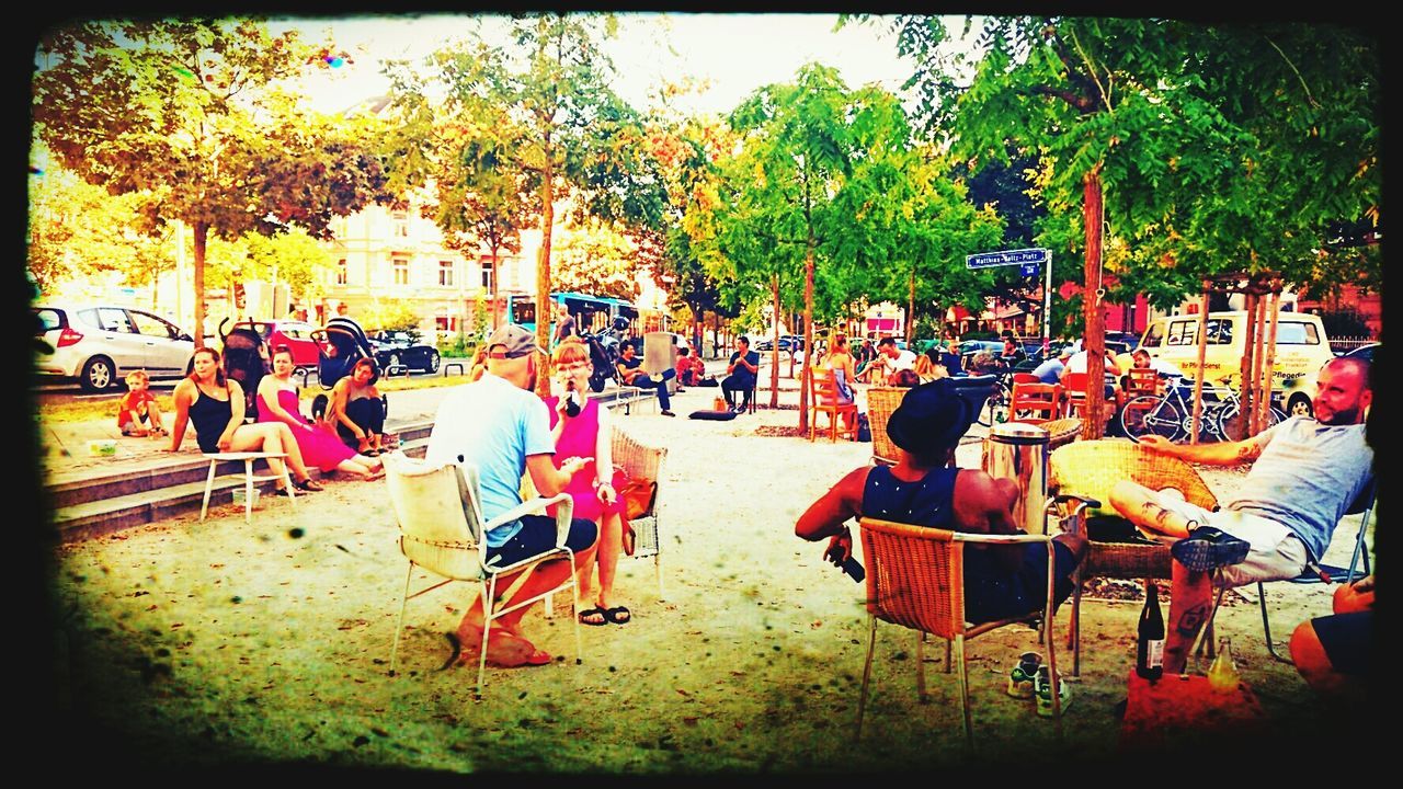 large group of people, real people, tree, table, men, outdoors, chair, women, day, sitting, crowd, nature, people, adult