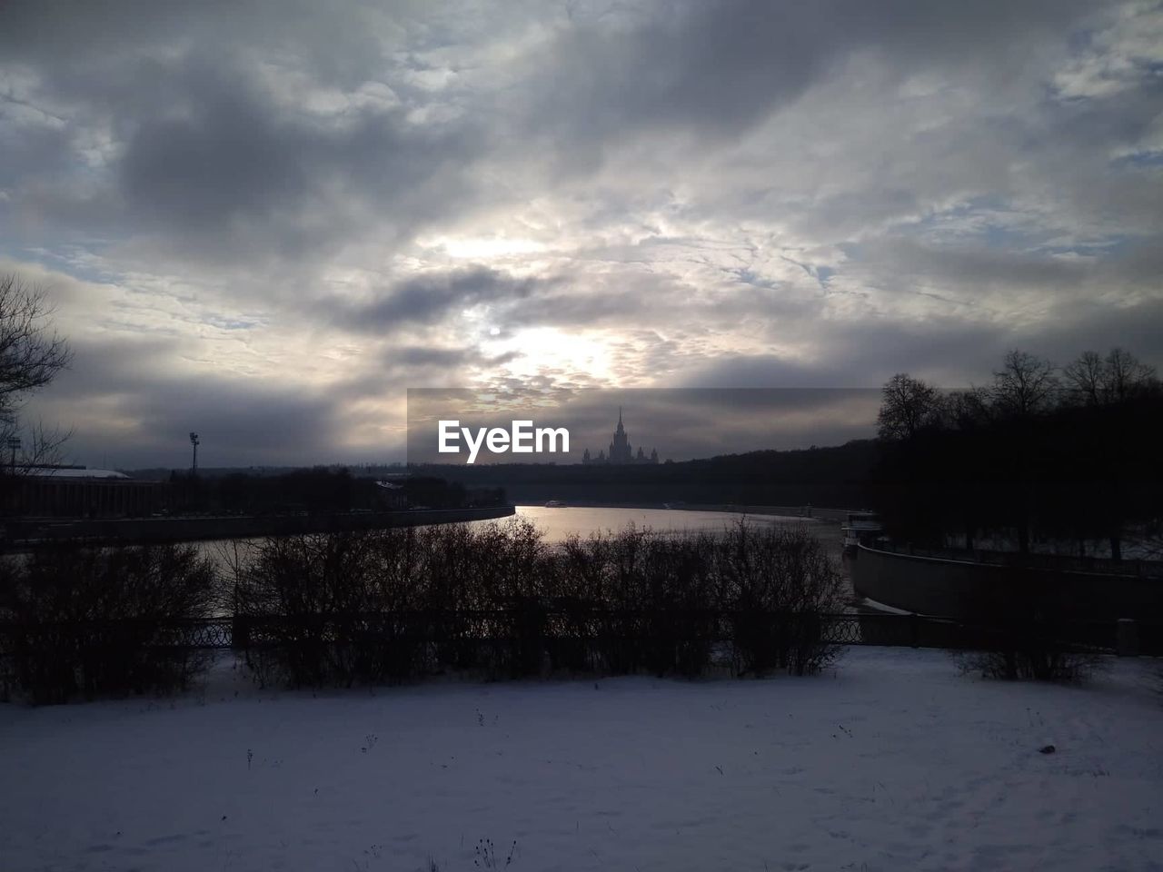 SCENIC VIEW OF FROZEN LAKE AGAINST SKY DURING WINTER