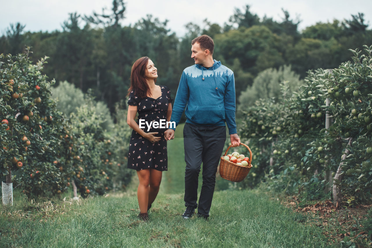 Man walking with pregnant woman at farm