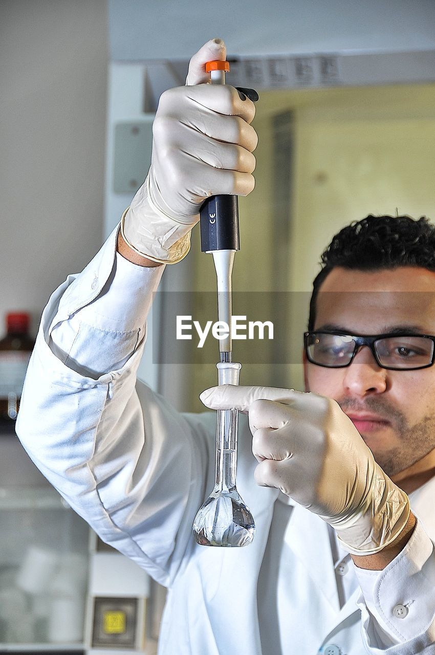 Close-up of scientist testing chemical in laboratory