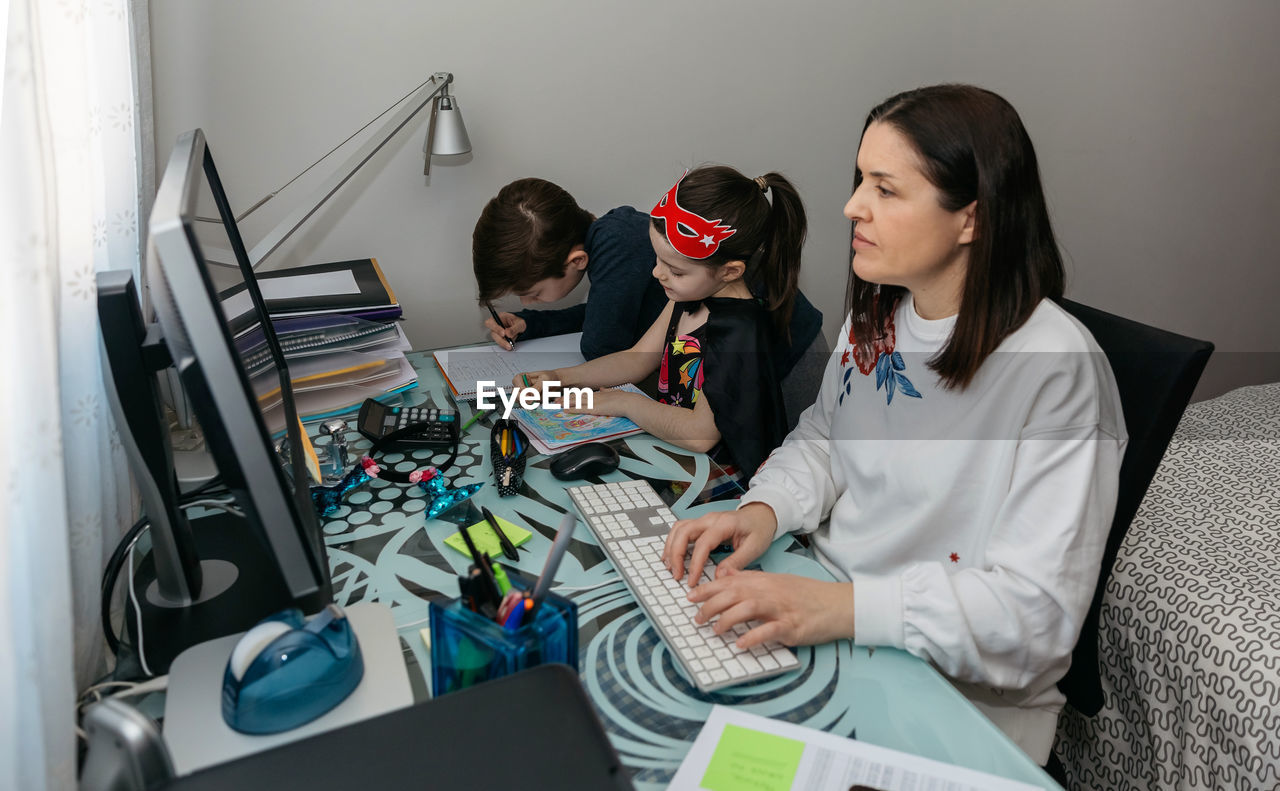 Women sitting on table at home