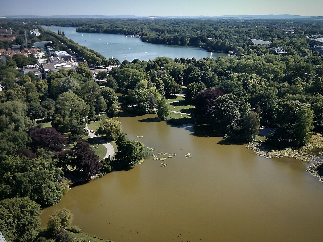 High angle view of calm lake along trees