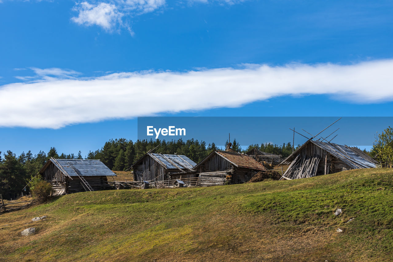 Houses on field against sky