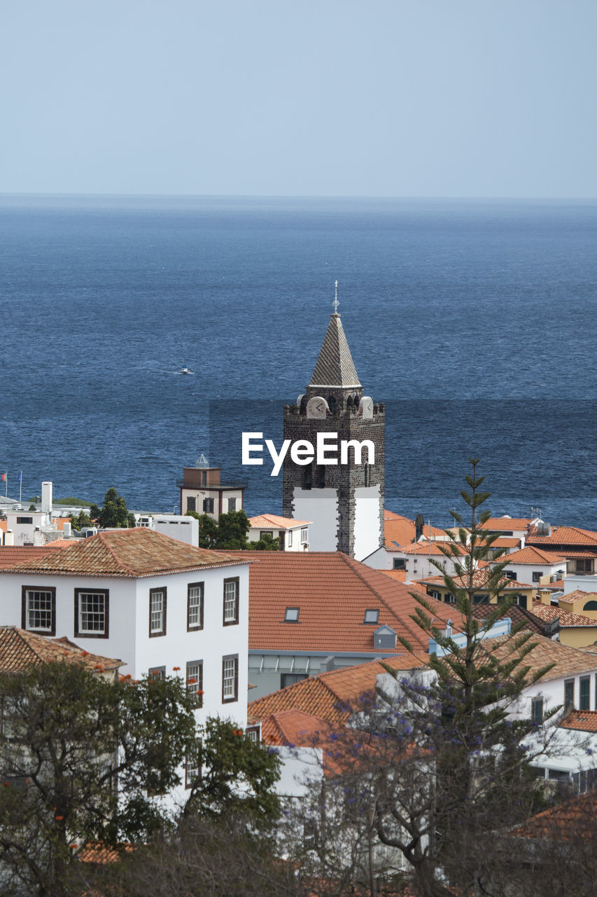 BUILDING BY SEA AGAINST SKY