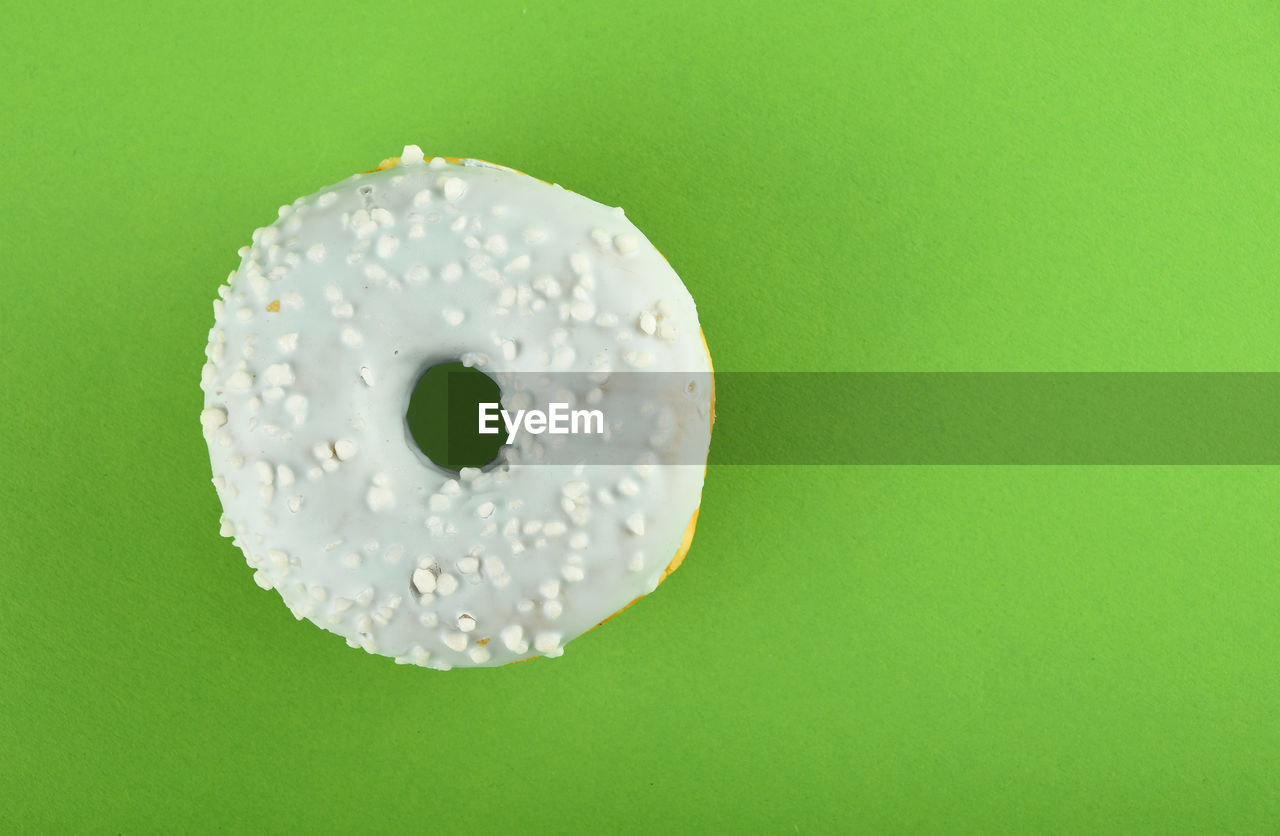 Close-up of donut on green background