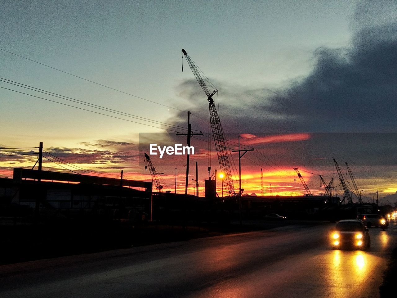 SILHOUETTE STREET AGAINST SKY DURING SUNSET