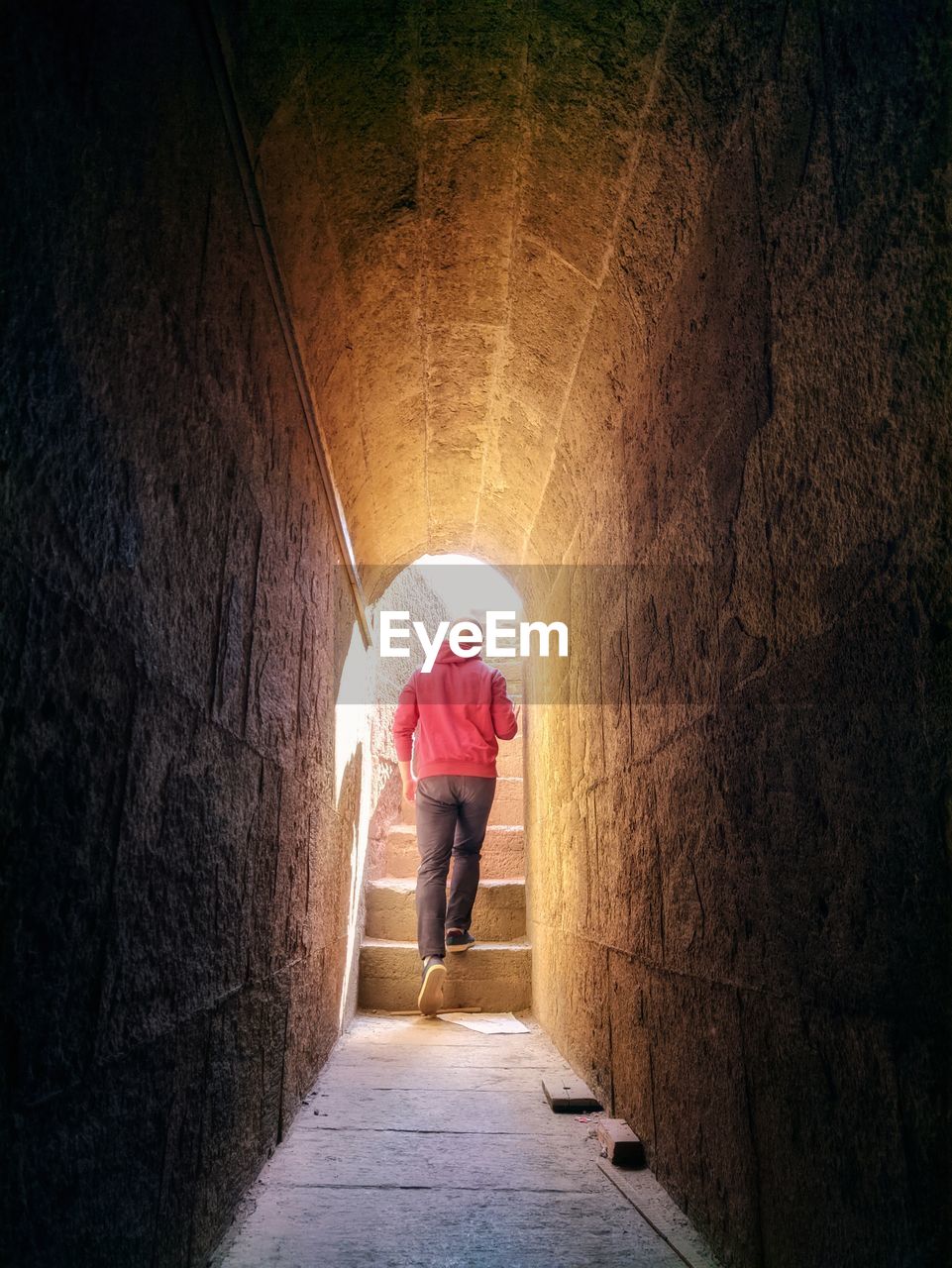 Man walking towards the light at the end of the tunnel with hope and motivation 