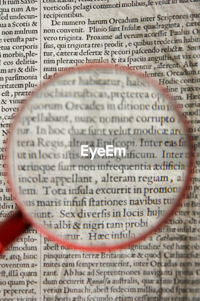 Close-up of magnifying glass over paper