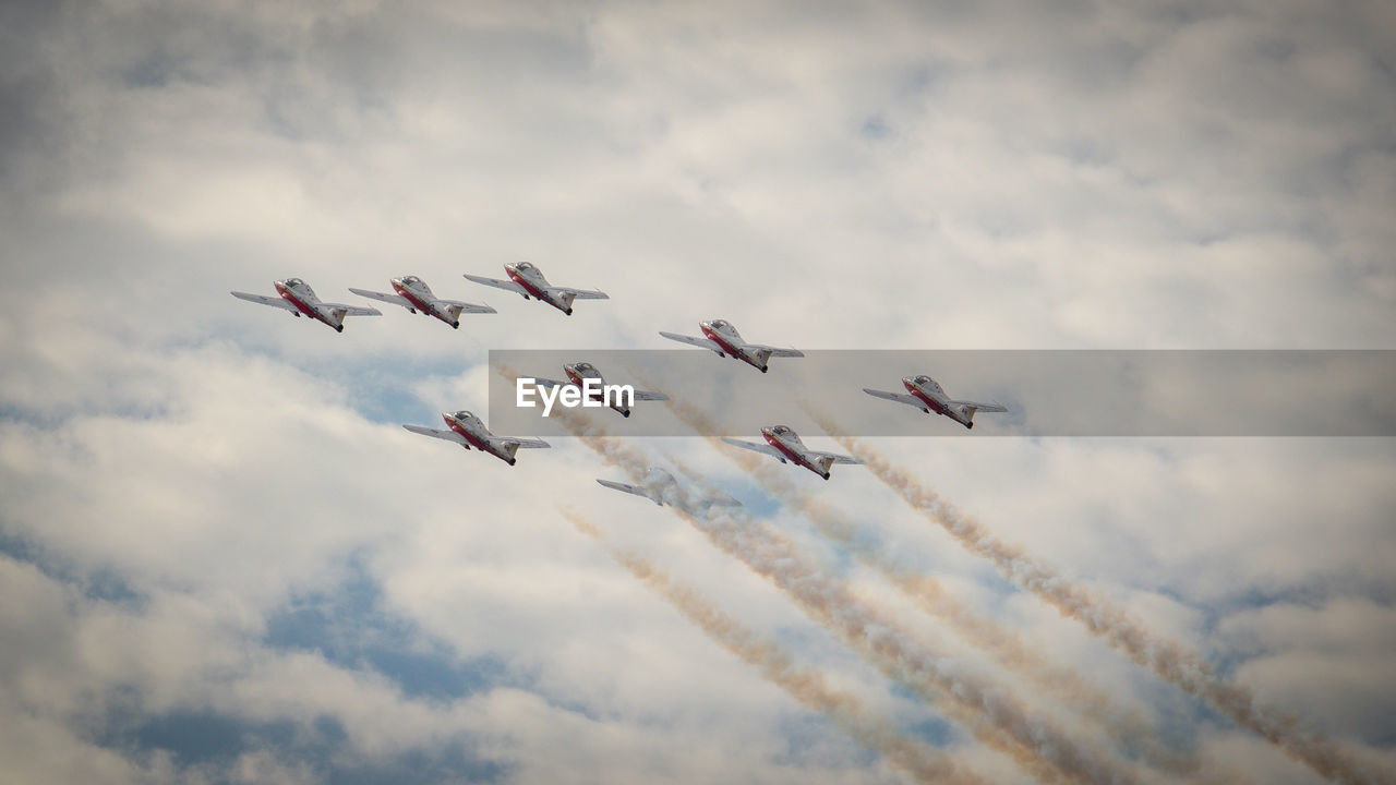 Low angle view of airshow against sky