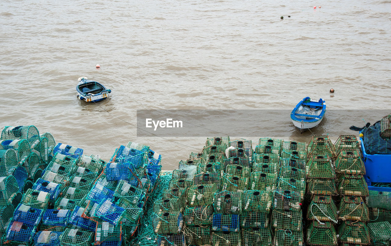 HIGH ANGLE VIEW OF FISHING NET ON SEA SHORE