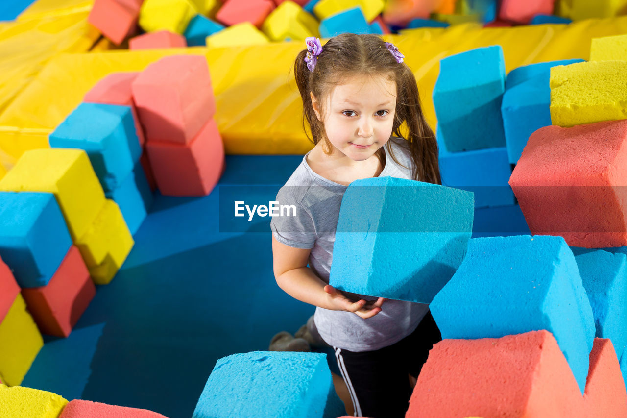 Portrait of a girl with colorful toys