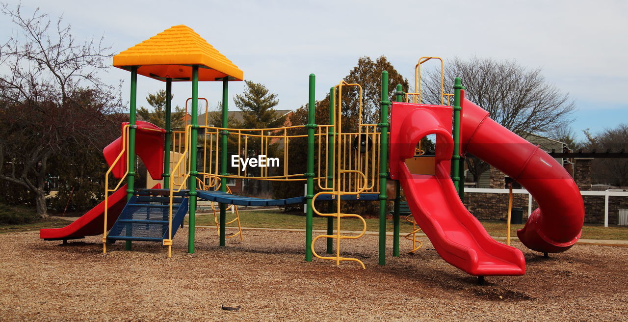 Slides on playground against sky