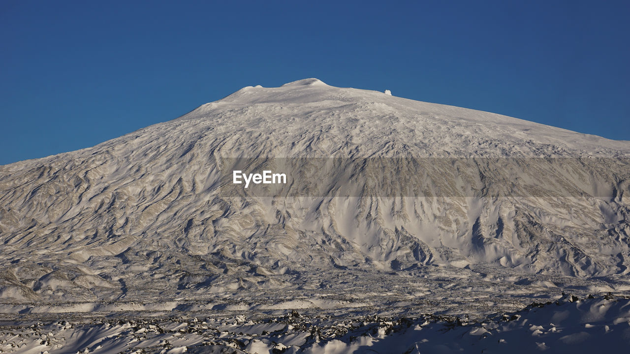 SCENIC VIEW OF SNOWCAPPED MOUNTAINS AGAINST BLUE SKY