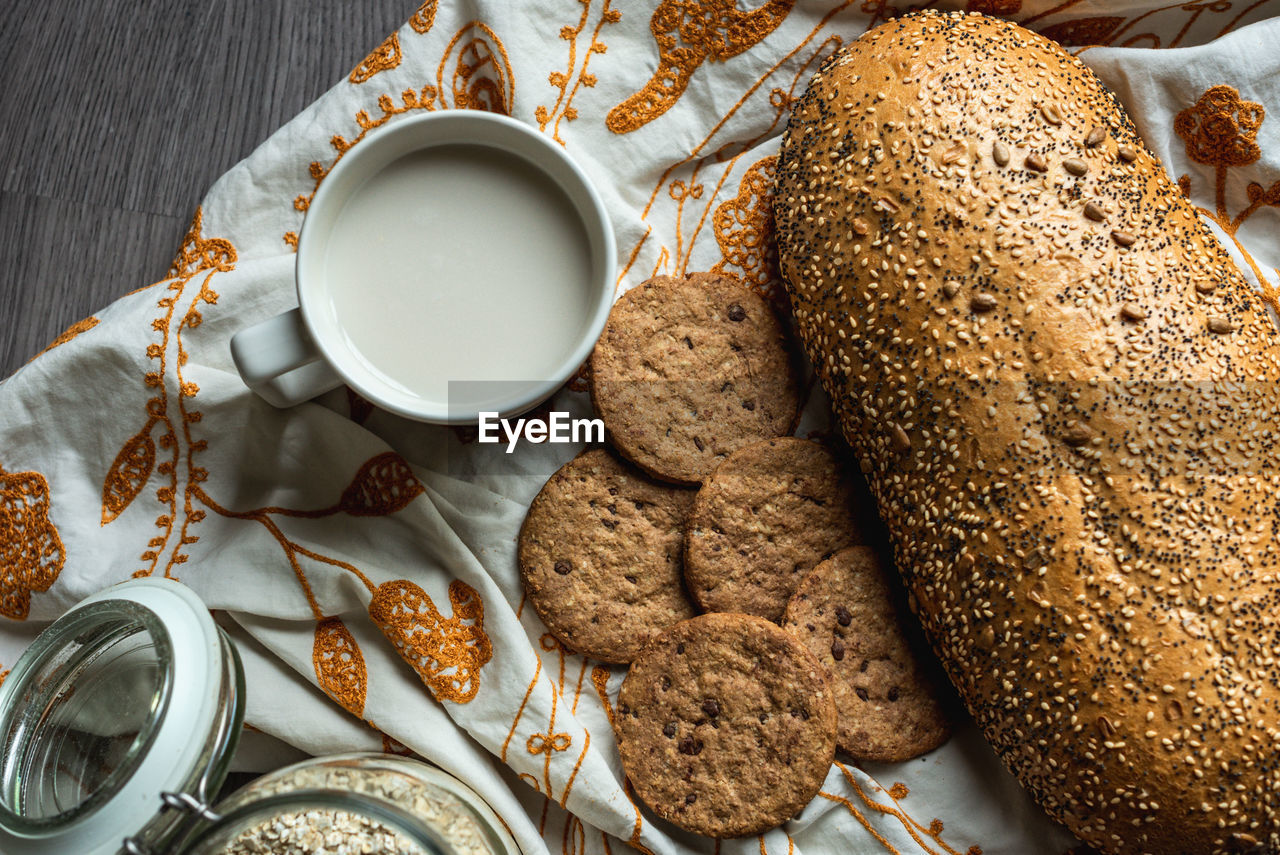 Breakfast with milk, bread, cookies and oats.