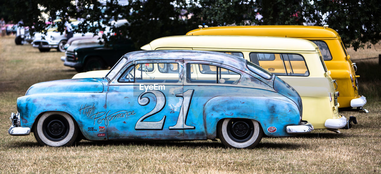 SIDE VIEW OF A CAR ON FIELD