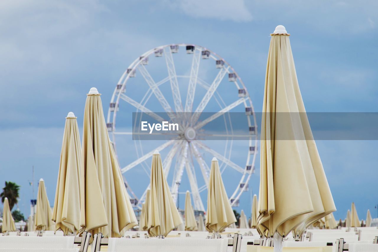 Low angle view of ferris wheel at beach against sky