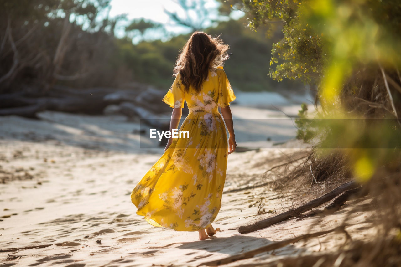 yellow, one person, women, spring, autumn, nature, sunlight, long hair, clothing, adult, hairstyle, dress, land, tree, fashion, walking, leaf, young adult, outdoors, flower, forest, summer, plant, full length, holiday, water, childhood, leisure activity, vacation, day, trip, child, happiness, female, rear view, motion, lifestyles, emotion, selective focus, enjoyment, environment, photo shoot, tranquility, rural scene, beauty in nature, blond hair, looking, brown hair, barefoot, smiling, solitude