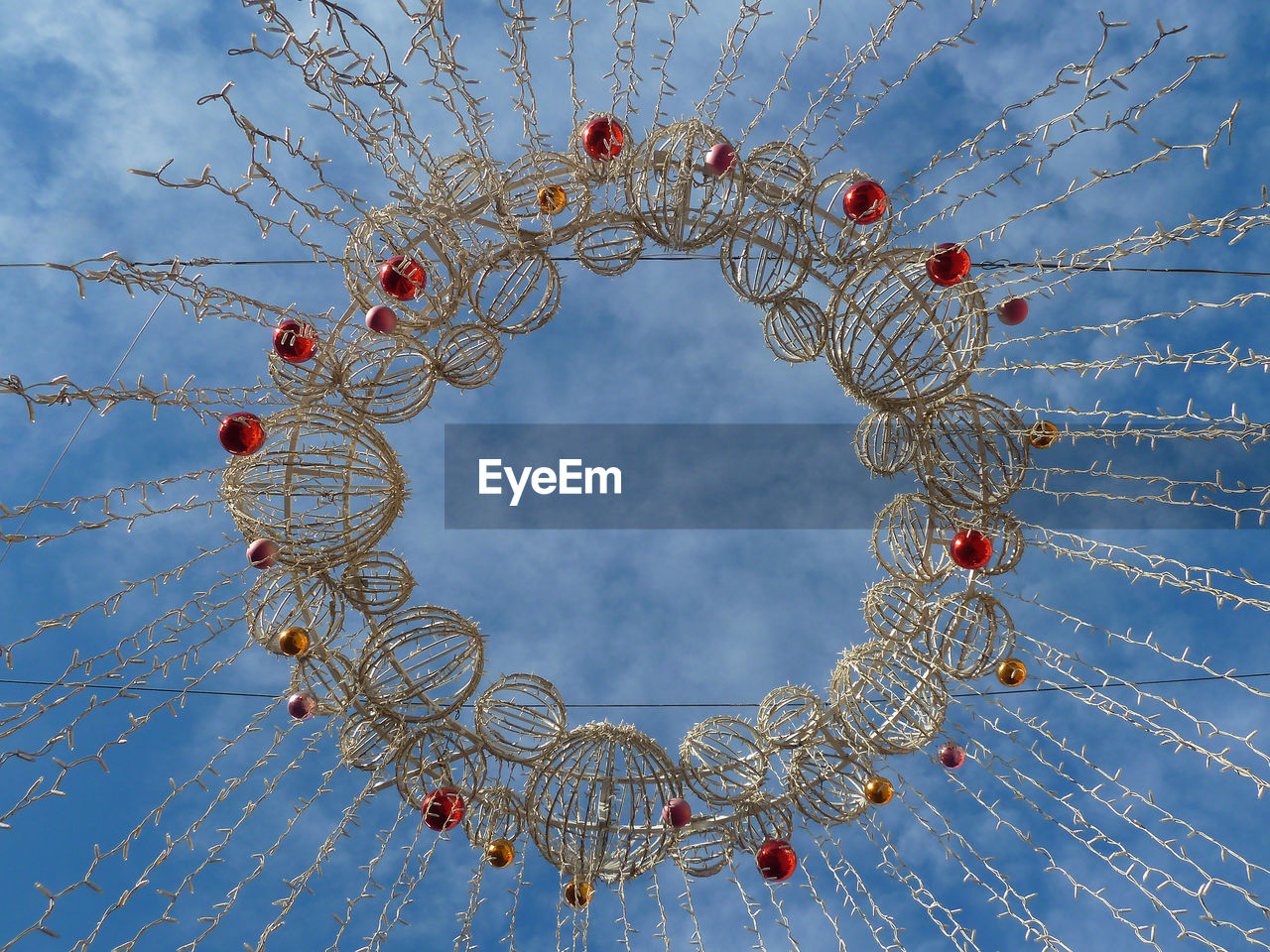 Low angle view of christmas decoration against blue sky