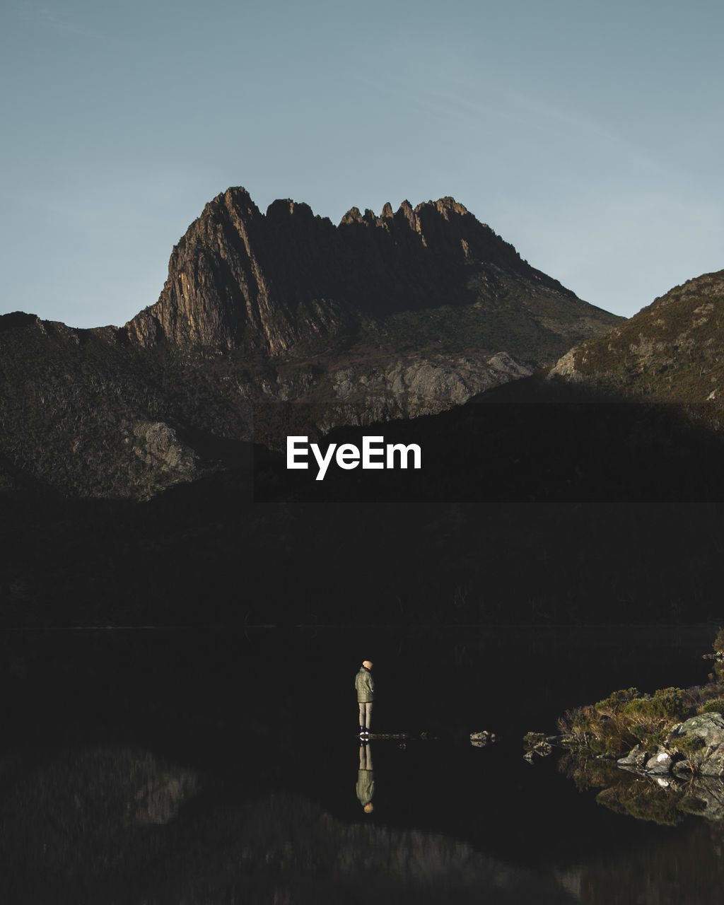 Man standing on dove lake against cradle mountain