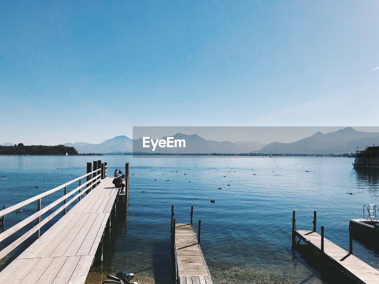 Pier over lake against sky