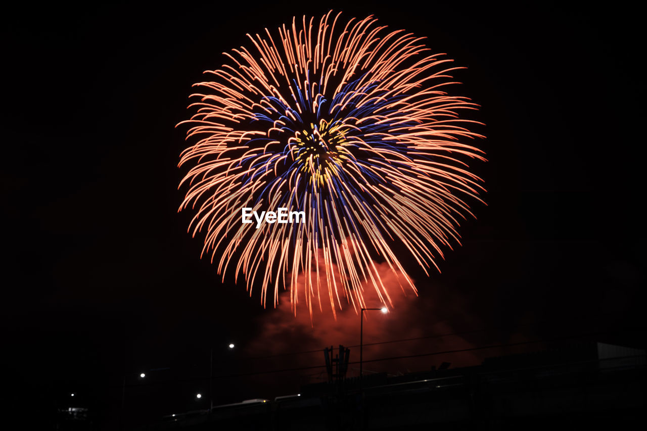 Low angle view of firework display at night