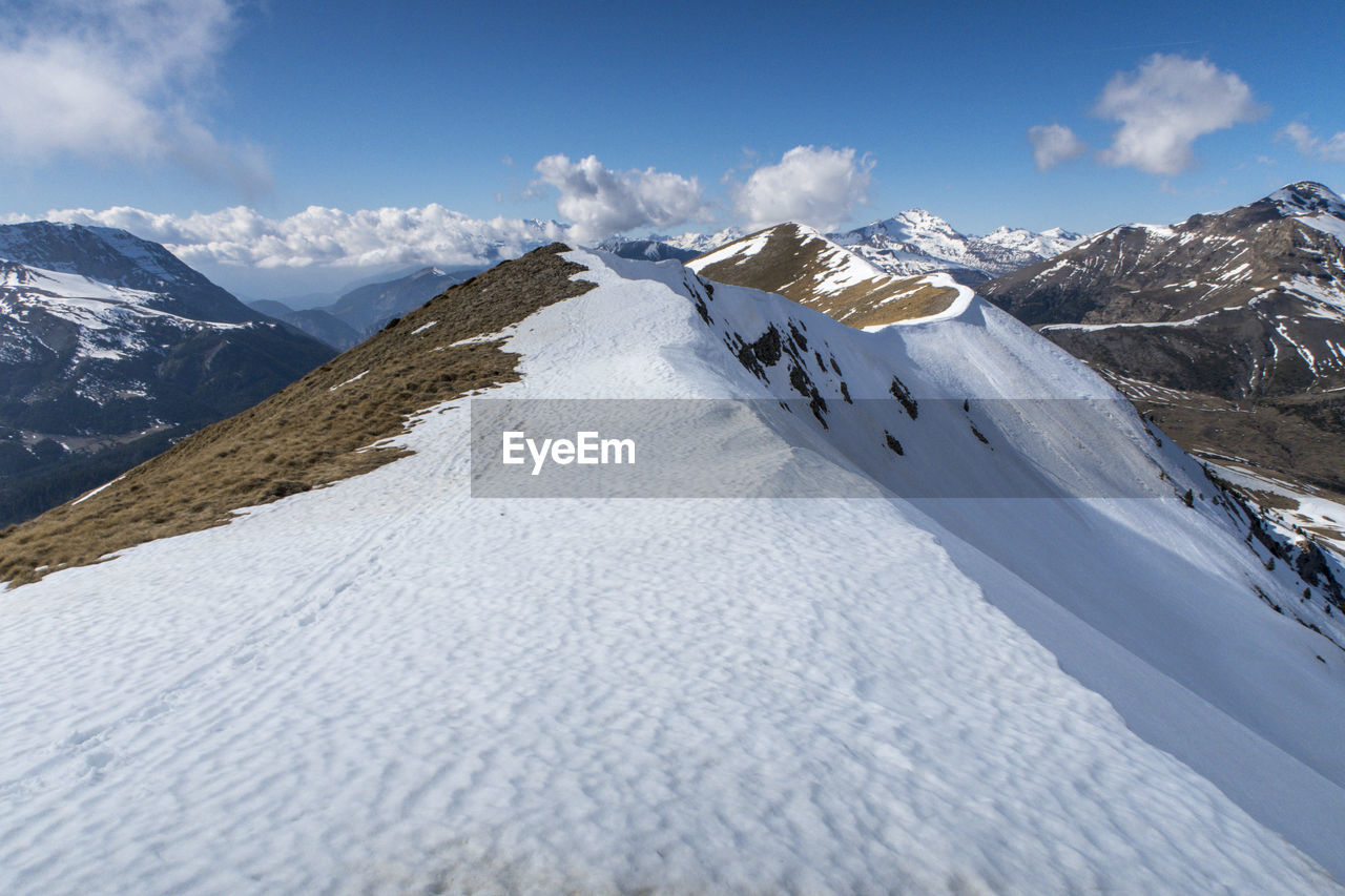 Scenic view of snowcapped mountains against sky