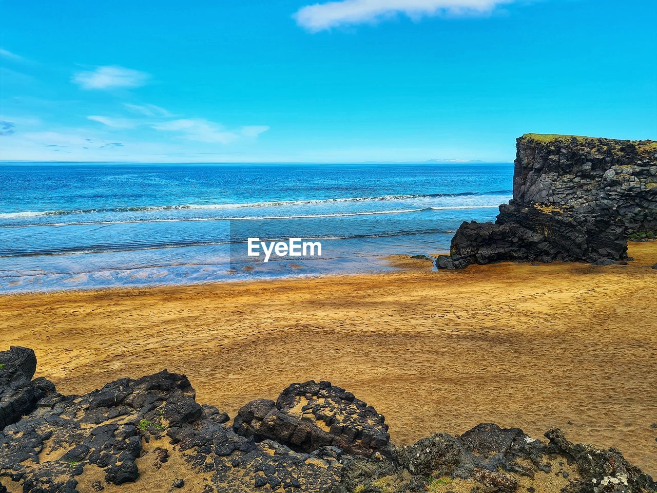 sea, land, beach, water, sky, rock, ocean, shore, horizon, scenics - nature, beauty in nature, coast, nature, horizon over water, body of water, cloud, cliff, wave, travel destinations, coastline, tranquility, no people, tranquil scene, sand, terrain, travel, motion, blue, rock formation, bay, vacation, outdoors, day, landscape, seascape, water sports, tourism, idyllic, trip, non-urban scene, environment, holiday, wind wave