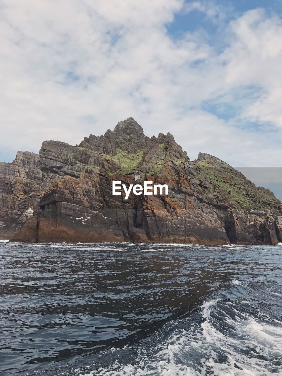 ROCK FORMATIONS ON SEA AGAINST SKY