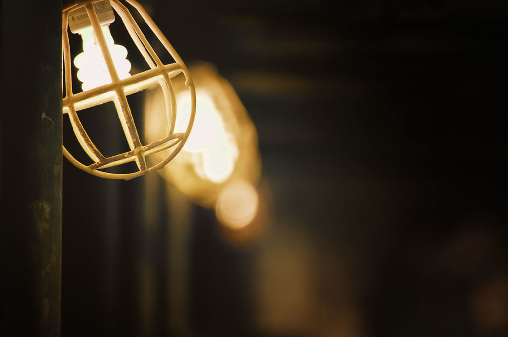 Low angle view of illuminated light bulbs in darkroom