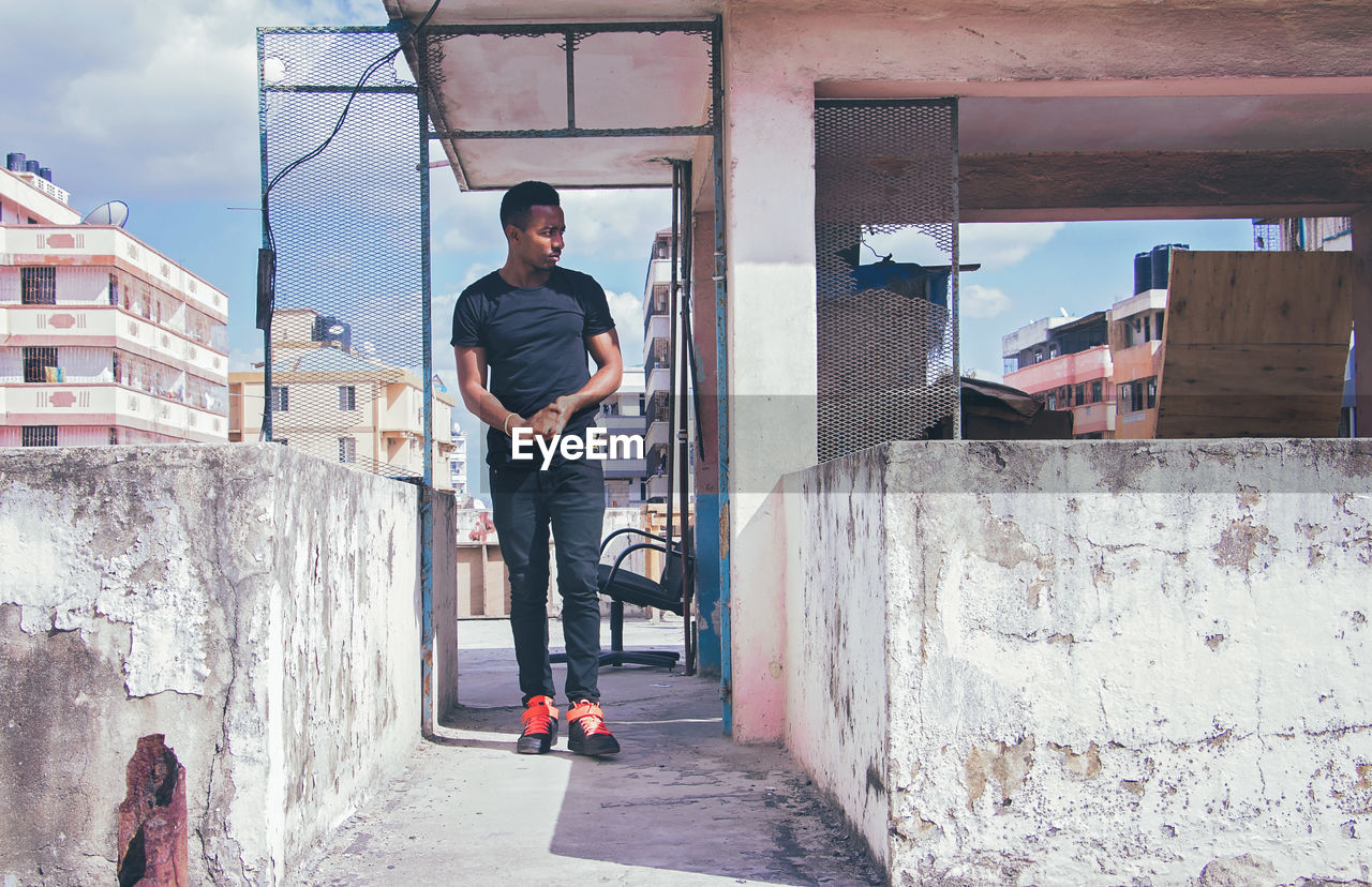 Young man standing on building terrace