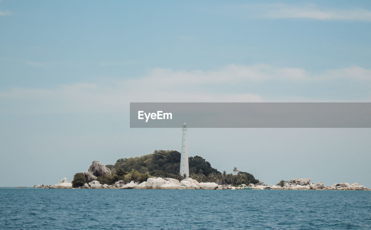SEA BY BUILDINGS AGAINST SKY