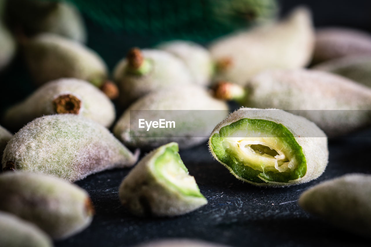 Close-up of green almonds on table